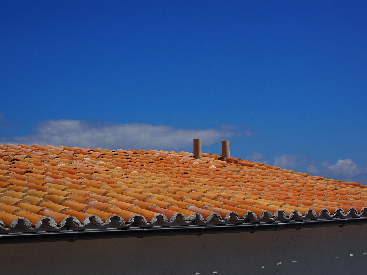 Close view of a flat roof with red panel sections on a residential property